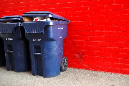 Construction workers loading waste into a builders skip