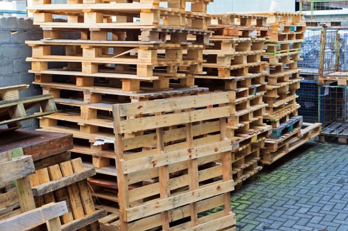 Vehicle and worker operating with PPE during skip loading